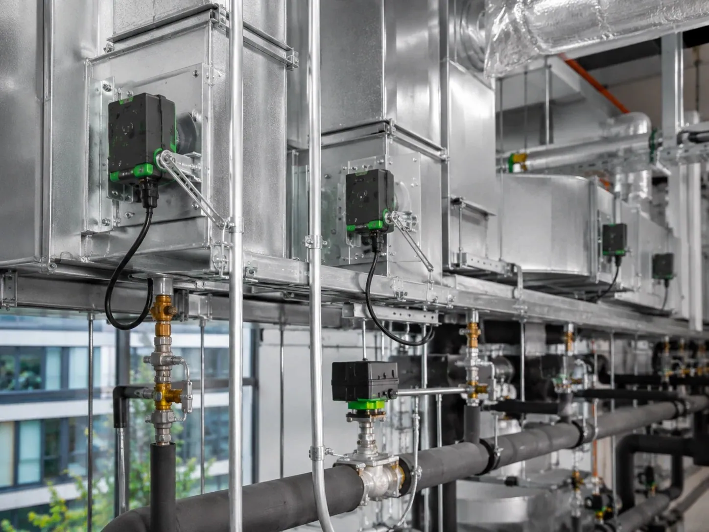 Damper and valve actuators mounted on air-handling ductwork and heating pipework