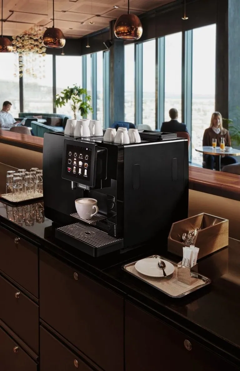 Professional coffee machine on a counter in a hotel lounge