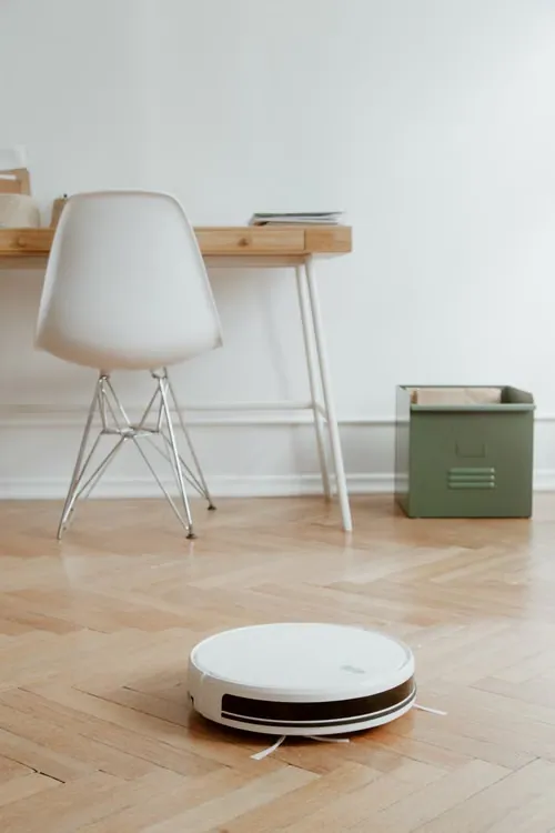 Robot vacuum cleaner operating on a parquet floor in a living room